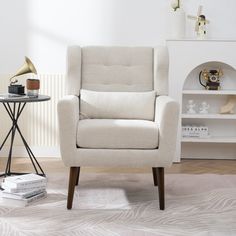 a white chair sitting next to a book shelf