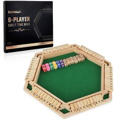 a wooden board game set with dices and dominos in front of the box