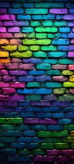 a brick wall with multicolored paint on the top and bottom half, as if it were painted in different colors