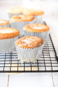 several muffins on a cooling rack with icing