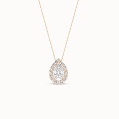 This Dewdrop Halo Necklace features a dewdrop-shaped diamond surrounded by a halo of tiny diamonds. The dewdrop-like setting creates a breathtaking visual experience, making this diamond pendant necklace perfect for any occasion, whether it’s a night out or a day at the office. It’s versatile enough to be worn with any outfit, from casual to formal. Timeless Diamond Necklace With Teardrop Pendant, Timeless Teardrop Pendant Diamond Necklace, Timeless Teardrop Diamond Necklace, Timeless Diamond Teardrop Pendant Necklace, White Gold Teardrop Pendant Necklace With Halo Setting, Timeless Teardrop White Diamond Necklace, Timeless Teardrop Halo Design Jewelry, Teardrop Diamond Necklace With Rose Cut Diamonds For Anniversary, Diamond White Teardrop Jewelry With Halo Setting