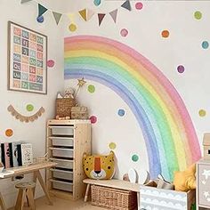 a child's room with a rainbow painted on the wall