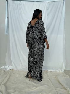 Indulge in the beauty of our classic kaftan with hand silk-screen printed fabric. This kaftan dress boasts unique patterns on high-quality rayon fabric. Its versatile design allows you to create many stylish looks, ensuring you always feel your best, whether you're at home or stepping out. Printed Flowy Kaftan For Beach Cover-up, Elegant Flowy Printed Kaftan, Patterned Printed Dresses With Relaxed Fit, Black Abstract Print Dress For Vacation, Black Beach Dress With Abstract Print, Black Dress With Abstract Print For Vacation, Black Maxi Dress With Abstract Print, Relaxed Fit Printed Patterned Dresses, Relaxed Fit Patterned Printed Dresses