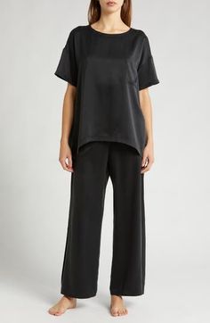 These mulberry-silk pajamas are naturally hypoallergenic, breathable and ideal for those with sensitive skin; best part—they can go in the washing machine. The elegant set pairs an oversized high-low T-shirt with flowy pants enhanced with split cuffs and side-seam pockets. Top has 28" front length, 30 1/2" back length; bottoms have 29" inseam, 25" leg opening, 12 1/2" front rise, 16 1/2" back rise (size Medium) Top has scoop neck; short sleeves; chest patch pocket; high/low hem Pants have back e Chic Silk Loungewear Sets, Relaxed Fit Satin Loungewear Sets, Elegant Solid Color Loungewear Sets, Elegant Silk Sleep Tops, Elegant Silk Nightwear Tops, Satin Loungewear Set With Relaxed Fit, Elegant Daywear Sets With Relaxed Fit, Elegant Relaxed Fit Daywear Sets, Elegant Relaxed Fit Sleepwear Long Pants