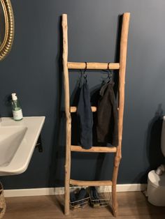 a wooden ladder leaning against the wall in a bathroom