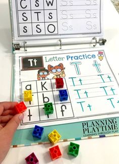 a person is playing with letters and numbers in a game set up on a table