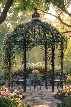 an outdoor gazebo surrounded by flowers and greenery