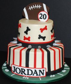 a football themed birthday cake with dog bones on the top and number 20 on the bottom