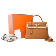 Amazing​ ​Hermes​ ​Kelly​ ​32​ ​sellier​ ​handbag​ ​strap​ ​in​ ​Camel​ ​(Gold)​ ​calf​ ​epsom​ ​leather​ ​,​ ​gold​ ​plated​ ​metal​ ​trim,​ ​camel​ ​leather​ ​handle,​ ​removable​ ​shoulder​ ​strap​ ​in​ ​camel​ ​leather​ ​for​ ​hand​ ​or​ ​shoulder​ ​carry Flap​ ​closure Gold​ ​leather​ ​interior​ ​lining,​ ​one​ ​zippered​ ​pocket,​ ​two​ ​patch​ ​pockets Signature:​ ​"Hermès​ ​Paris​ ​Made​ ​in​ ​France​ ​​ ​​ ​" Stamp:​ ​W​ ​(2024) Dimensions:​ ​32x23x12​ ​cm​ ​(12,6x9x4,7​ ​Inches) Shoulder​ ​strap​ ​length:​ ​90​ ​cm​ ​(35.4​ ​Inches) Reference:​ ​101786 General​ ​condition:​ ​9.5/10 Sold​ ​Full​ ​set​ ​with​ ​copy​ ​of​ ​the​ ​Hermès​ ​invoice,​ ​removable​ ​shoulder​ ​strap,​ ​tirette,​ ​clochette,​ ​padlock,​ ​keys,​ ​felt,​ ​dustbag,​ ​ribbon​ ​and​ ​box Pristine​ ​condition-​ France Stamp, Hermes Kelly 32, Kelly 32, Handbag Strap, Fancy Bags, Hermes Paris, Metal Trim, Handbag Straps, Gold Leather