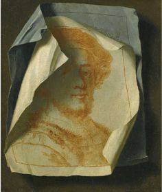 an image of a man's face on a piece of paper that has been folded in half