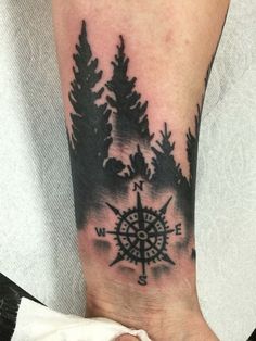 a person with a compass tattoo on their arm