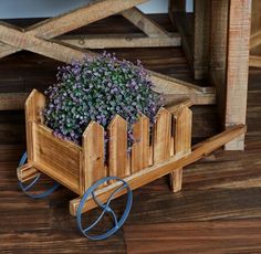 a small wooden cart with flowers in it