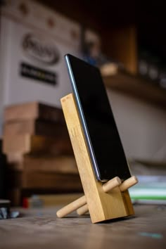 a wooden stand with a cell phone on it