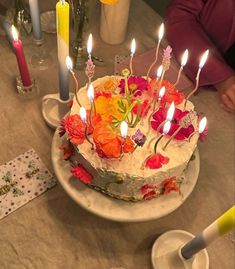 a birthday cake with lit candles on it