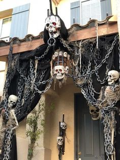 a couple of skeletons hanging from the side of a building with chains attached to it