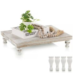 a wooden table topped with a plant and beads