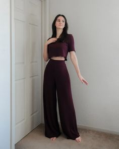 a woman standing in front of a white door