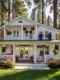 a white house with flowers on the porch