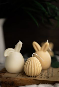 three candles sitting on top of a wooden board