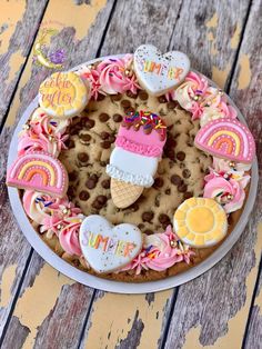 a cookie decorated with ice cream, cookies, and other treats on a plate that says happy birthday