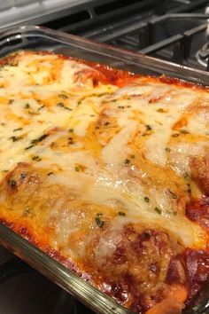 a casserole dish with meat, cheese and sauce in it on the stove