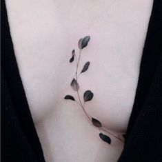 a woman's chest with small leaves on the top and bottom part of her stomach