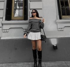 I’m wearing an oversized off-shoulder grey sweater, a white balloon skirt, tall black leather boots, and a black baguette bag, standing against a stylish urban backdrop. Baloon Skirt Outfit Ideas, Mid Season Outfit, Balloon Skirt Outfit, Tall Black Leather Boots, Leather Boots Outfit, Outfit Old Money, 2024 Fits, Korea Trip, White Leather Boots