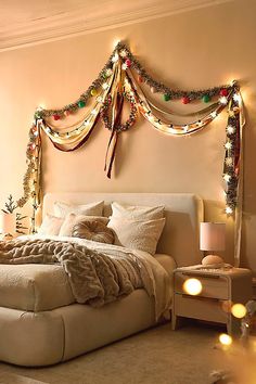 a large bed with lights on the headboard and foot board in front of it