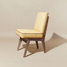 a wooden chair with a yellow upholstered seat and back rest, on a beige background