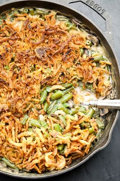 green bean casserole with bacon and onions in a skillet