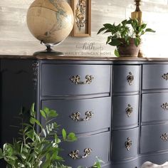 a blue dresser with some plants on top of it