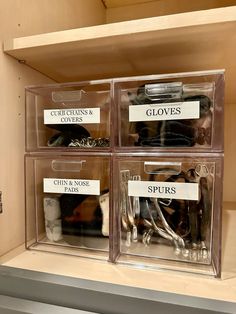 three clear bins with labels on them containing clothes and gloves in the closet for storage