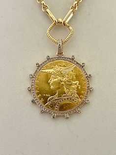 Beautiful reproduction vintage coin pendant, French Madagascar coin in a bezel with cubic zirconia stones. The bale attached to the coin is also encrusted with CZ stones. The coin is 22k gold plated and elegantly hangs from a multi link gold plated brass chain and a rope design spring lock clasp. The spring lock closure not only makes it easy to open and close the necklace for those with difficulty but adds to the creativity of the jewelry piece. Please see photograph of how to open the clasp. W Luxury Yellow Gold Coin Medallion Necklace, Luxury Gold Coin Medallion Necklace, Gold Collectible Medallion Necklace, Luxury Yellow Gold Medallion Coin Necklace, Yellow Gold Coin Necklace For Anniversary, Luxury Engraved Coin Necklace, Luxury Yellow Gold Coin Pendant Necklace, Diamond Coin Pendant Jewelry, Hallmarked Yellow Gold Coin Necklace