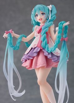 a doll with blue hair and pink dress is holding two white ribbons in her hands