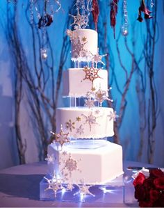 a three tiered white cake sitting on top of a table