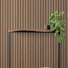 a chair and table in front of a wooden wall with vertical stripes on the wall