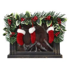 two stockings hanging from a mantle with holly and red stocking on it's sides