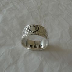 This is 925 sterling silver ring Love heart/Mama ring, with a hammered/oxidized finish in places Handcrafted using recycled silver  UK size N 1/2 (US 7) Height of the face 0.9cm Weight-4.4gms There is a 925 stamp inside the band and the word "Mama" UK delivery is free and 1st class, letterbox friendly and there is a tracking number which provides delivery confirmation. Europe/Worldwide-The standard delivery charge is not tracked, however there is the option at the checkout for a tracked service. Silver Hand Stamped Rings For Mother's Day, Handmade Sterling Silver Rings For Mother's Day, Mama Ring, Gift For Mum, Mothersday Gifts, Recycled Silver, Gifts For Mum, 925 Sterling Silver Ring, Sterling Silver Ring