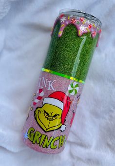 the grinch drink can is decorated with glitter and candy canes on it's side