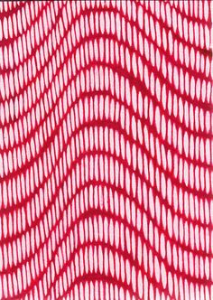 a red and white knitted fabric with wavy lines in the center, as seen from above