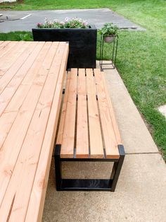 a wooden bench sitting on top of a sidewalk