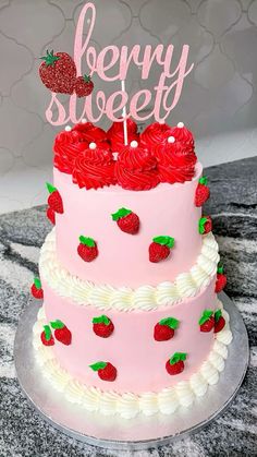 there is a pink cake with strawberries on it and the words berry sweet written on top