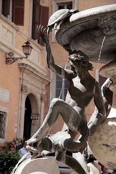 a statue is shown in front of a fountain