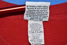 a red shirt with a label on it that says, the man's world