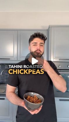 a man holding a bowl of food in front of his face with the words tahn roasted chickpeas