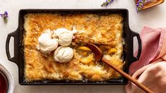 a casserole dish with some ice cream on top and flowers in the background