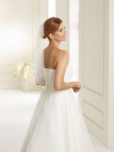 a woman in a wedding dress looking back