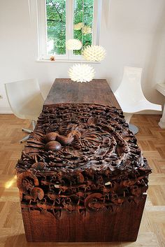 a large wooden table with intricate carvings on it