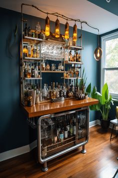 A stylish home bar with hanging lights, assorted liquor bottles on shelves, a wooden counter, and a cooler underneath, set against a deep blue wall. Industrial Style Game Room, Adult Game Room With Bar, Game Room Bar Industrial, Game Room Bar Rustic, Neon Sogn Game Room, Home Bar Setup, Basement Games, Whiskey Room