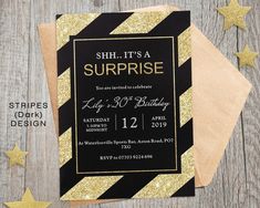 black and gold surprise birthday party with stars on the table next to paper napkins